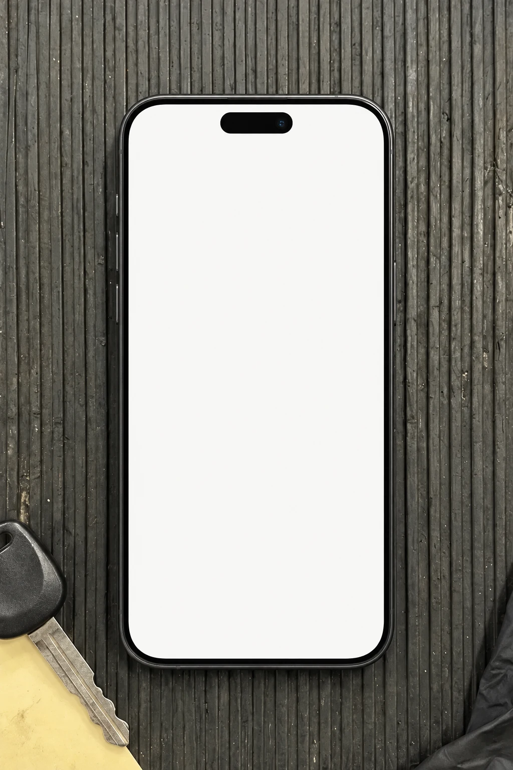 A modern iPhone on a mechanic’s tool chest, next to a car key with a paper tag.